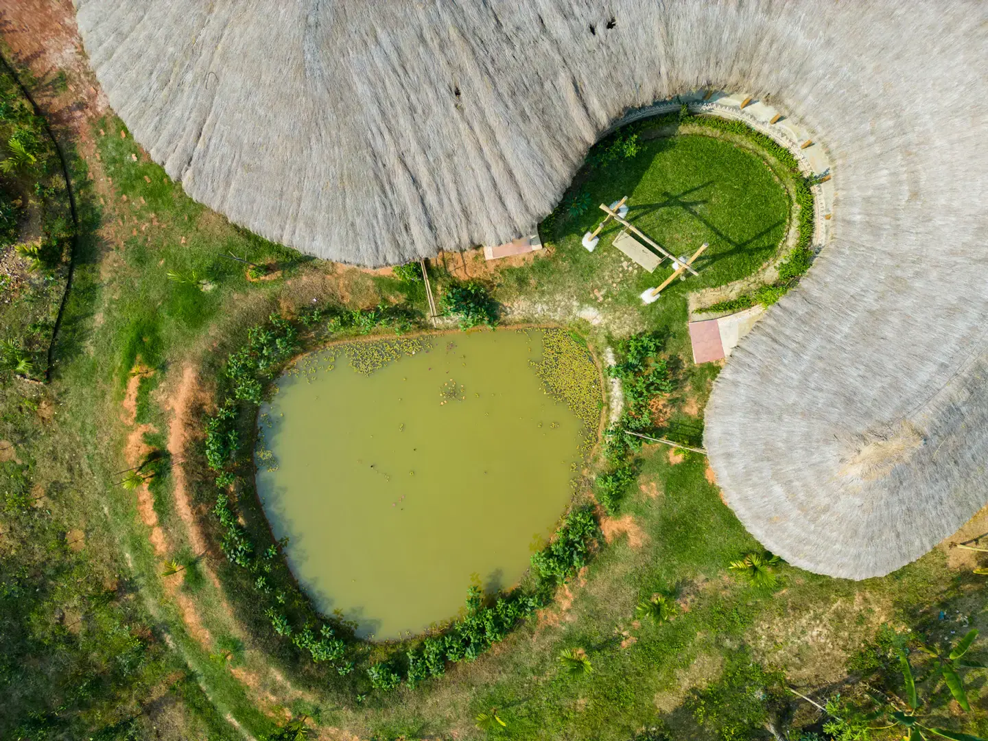 Aerial view of the pond and roofscape of the Eco Vacation House